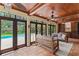 Inviting sunroom with wood ceiling, tile floors, and views of the pool and backyard at 1110 Greenwood St, Orlando, FL 32801