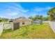 Charming home exterior featuring a private backyard, screened pool enclosure, and solar panels at 114 Dolcetto Dr, Davenport, FL 33897