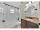 Bathroom with granite-look vanity, tub-shower combo, tile flooring, and bright vanity lighting at 114 Dolcetto Dr, Davenport, FL 33897