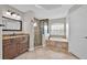 Bright bathroom features a walk-in shower, soaking tub, and double sink vanity at 114 Dolcetto Dr, Davenport, FL 33897