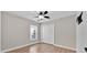 Bedroom features a ceiling fan, a window with blinds, and wood-look tile flooring at 114 Dolcetto Dr, Davenport, FL 33897