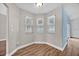 Cozy dining area with three windows, wood-look tile flooring, and neutral wall colors at 114 Dolcetto Dr, Davenport, FL 33897