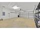 Spacious two-car garage offers ample storage space, work area, and a convenient automatic door at 114 Dolcetto Dr, Davenport, FL 33897