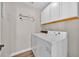 This laundry room features a washer and dryer with white cabinets above at 114 Dolcetto Dr, Davenport, FL 33897