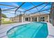 Inviting screened-in pool area with a sparkling pool, patio, and views of the backyard at 114 Dolcetto Dr, Davenport, FL 33897