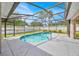Sparkling pool surrounded by a screened enclosure, offering privacy and a refreshing escape at 114 Dolcetto Dr, Davenport, FL 33897