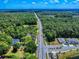 Wide aerial view showing a neighborhood landscape, including houses, a pond, and a well-maintained road at 1155 Taylor E Rd, Deland, FL 32724