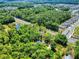 Aerial view of a neighborhood landscape, including houses, a pond, and a well-maintained road at 1155 Taylor E Rd, Deland, FL 32724