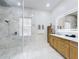 Modern bathroom with marble shower stall, wood cabinet vanity, and illuminated mirror at 1155 Taylor E Rd, Deland, FL 32724