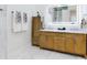 Bathroom with wood vanity, marble countertop, towels, and illuminated mirror at 1155 Taylor E Rd, Deland, FL 32724
