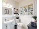 Stylish half-bathroom with pedestal sink, ornate mirror, and stained glass window at 1155 Taylor E Rd, Deland, FL 32724