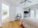 Well-lit bedroom featuring hardwood floors, ensuite bath access, and a ceiling fan at 1155 Taylor E Rd, Deland, FL 32724