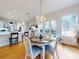 Bright dining area with wood floors, chandelier, and access to the kitchen and backyard at 1155 Taylor E Rd, Deland, FL 32724