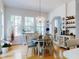 Bright dining area with wood floors, chandelier, and large windows overlooking the yard at 1155 Taylor E Rd, Deland, FL 32724