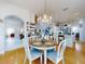 Bright dining area with wood floors, chandelier, and open concept floorplan at 1155 Taylor E Rd, Deland, FL 32724