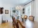 Dining room with wood floors, chandelier, table setting, and view of the staircase at 1155 Taylor E Rd, Deland, FL 32724