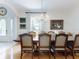 Bright dining room with wood floors, chandelier, large windows, and seating for eight at 1155 Taylor E Rd, Deland, FL 32724