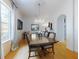Elegant dining room featuring a chandelier, large windows, and a wooden table with seating for eight at 1155 Taylor E Rd, Deland, FL 32724