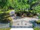 Long, private driveway leading to a beautiful home, framed by lush trees and manicured landscaping at 1155 Taylor E Rd, Deland, FL 32724