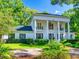 Stately two-story home with white pillars and lush landscaping in a desirable neighborhood, providing curb appeal at 1155 Taylor E Rd, Deland, FL 32724