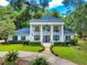 A stately home with white columns, beautiful landscaping, and a circular driveway at 1155 Taylor E Rd, Deland, FL 32724