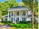 A stately home with white columns, beautiful landscaping, and a circular driveway at 1155 Taylor E Rd, Deland, FL 32724