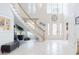 Two-story foyer showcasing tile floors, a graceful staircase, chandelier, and ample natural light at 1155 Taylor E Rd, Deland, FL 32724