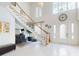 Spacious foyer with tile flooring, grand staircase, chandelier, and beautiful design features, creating a grand entrance at 1155 Taylor E Rd, Deland, FL 32724