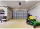 Spacious garage with modern door, lawn equipment, and ample storage space at 1155 Taylor E Rd, Deland, FL 32724