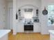 Clean kitchen featuring stainless steel appliances, white cabinetry, and hardwood floors at 1155 Taylor E Rd, Deland, FL 32724