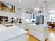 Spacious white kitchen featuring a large island, stainless steel appliances, and hardwood flooring at 1155 Taylor E Rd, Deland, FL 32724