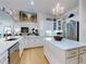 Bright, open-concept kitchen with white cabinetry, a central island, and stainless steel appliances at 1155 Taylor E Rd, Deland, FL 32724