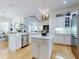 Bright kitchen with white cabinetry, marble counters, central island, stainless appliances, and chandelier at 1155 Taylor E Rd, Deland, FL 32724