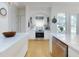 Well-equipped kitchen featuring stainless steel appliances, white cabinetry, and hardwood floors at 1155 Taylor E Rd, Deland, FL 32724