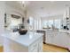 Bright kitchen with white cabinets, a large island, stainless steel appliances, and hardwood floors at 1155 Taylor E Rd, Deland, FL 32724