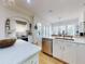 Well-lit kitchen featuring stainless steel appliances, white cabinetry, and hardwood floors at 1155 Taylor E Rd, Deland, FL 32724