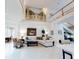 Bright living room featuring tile floors, comfortable seating, soaring ceilings, and staircase access creating an open ambiance at 1155 Taylor E Rd, Deland, FL 32724