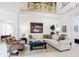 Bright living room showcasing tile floors, comfortable seating, decorative art, and natural lighting with staircase nearby at 1155 Taylor E Rd, Deland, FL 32724