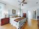 Spacious main bedroom with four-poster bed, wood floors, and ensuite bathroom at 1155 Taylor E Rd, Deland, FL 32724