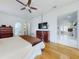 Spacious main bedroom with wood floors, ceiling fan, and view into the living area at 1155 Taylor E Rd, Deland, FL 32724