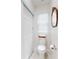 Powder room featuring modern toilet, wood-framed mirror and tiled floor at 1155 Taylor E Rd, Deland, FL 32724