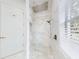 Modern shower with large shower head, white marble tile, and glass door at 1155 Taylor E Rd, Deland, FL 32724