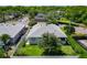 An aerial view showcasing a well-maintained home, mature trees, and manicured lawns, in a beautiful neighborhood at 1157 Valley Creek Run, Winter Park, FL 32792