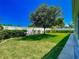 Spacious backyard featuring lush green lawn, mature trees, and a white privacy fence at 1157 Valley Creek Run, Winter Park, FL 32792