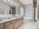 Bathroom featuring a double vanity, soaking tub, and glass enclosed shower at 1157 Valley Creek Run, Winter Park, FL 32792