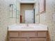 This bathroom has floral wallpaper, vanity with shelves and mirror, and decorative light fixture at 1157 Valley Creek Run, Winter Park, FL 32792