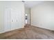 This bedroom features neutral walls, carpet and a closet with bifold doors for ample storage space at 1157 Valley Creek Run, Winter Park, FL 32792