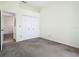 This bedroom features neutral walls, carpet and a closet with bifold doors for ample storage space at 1157 Valley Creek Run, Winter Park, FL 32792