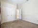 This bedroom features neutral walls, carpet and a closet with bifold doors for ample storage space at 1157 Valley Creek Run, Winter Park, FL 32792