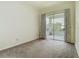This bedroom features neutral walls, carpet and sliding glass doors leading to a screened in porch at 1157 Valley Creek Run, Winter Park, FL 32792